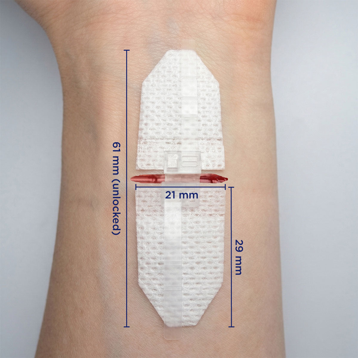 DermaClip Large single clip applied to wrist showing 21mm clip width, 29mm pad length, 61mm total device length